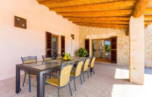 a dining room with a black table and yellow chairs at Pula Bonavista Ref 140 in Costa des Pins