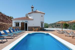 una villa con piscina frente a un edificio en Sunset El Tejar, en Almogía