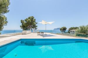 a swimming pool with a view of the ocean at Casa Viviana in Moraira