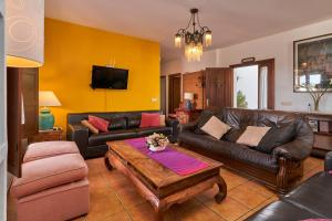 a living room with a couch and a table at Group Villa 14 Pool wifi Air in Frigiliana