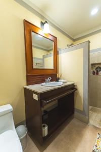 a bathroom with a sink and a mirror at Casa Santiago Merida by WoWay Experiences in Mérida +16 photos