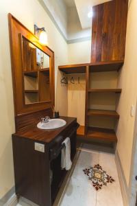 a bathroom with a sink and a mirror at Casa Santiago Merida by WoWay Experiences in Mérida