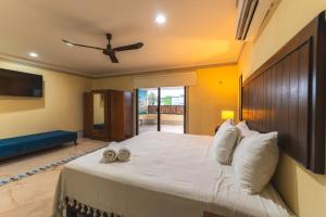 a bedroom with a large bed with two towels on it at Casa Santiago Merida by WoWay Experiences in Mérida