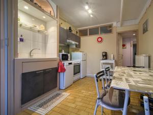 a kitchen and dining room with a table and chairs at Gite La Bastide De La Coda in Châteauneuf-du-Rhône +6 photos