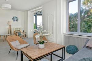 a living room with a table with flowers on it at La Maison de Port Lin in Le Croisic
