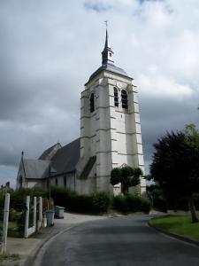 a church with a tower with a clock on it at La petite auberge in Canaples