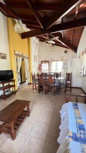 a living room with a table and a dining room at Cabañas Aldea Blanca in Merlo