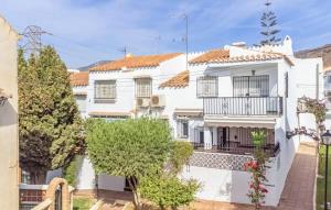 a white house with a balcony and trees at Casa Colibri 2 Beach Nerja in Nerja
