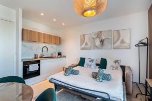 a room with a bed with blue pillows on it at Appartement proche croisette in Cannes