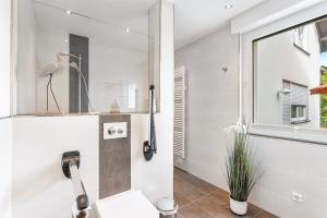 a bathroom with a sink and a bird on the wall at Ferienwohnung Kleine Auszeit in Eslohe +28 photos