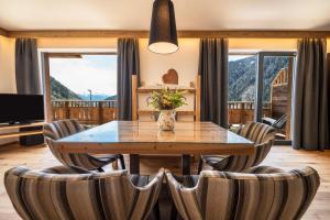a dining room with a table and chairs at App Mulin Tondl mit Sauna in Mühlbach +23 photos
