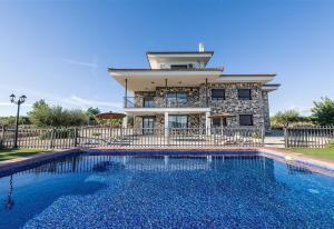 a house with a swimming pool in front of a house at Casa Rural la Montana 1 in Chella