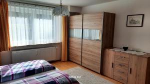 a bedroom with a bed and a dresser and a window at Haus Broni in Prem