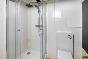 a bathroom with a glass shower with a toilet at im Fachwerk in Alsfeld +12 photos