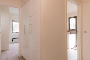 a room with white walls and a sliding door at Bicheno Sands-space and the sea in Bicheno +26 photos