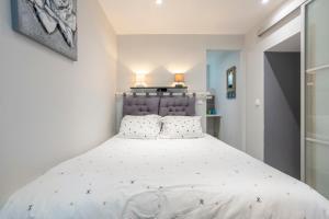 a bedroom with a large white bed with two pillows at L' Eclose Ty Gwen in Le Guilvinec