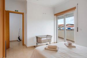 a bedroom with a bed with two towels on it at A O - Tina House Ferrel in Ferrel