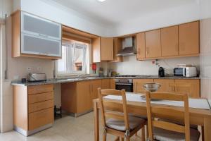 a kitchen with wooden cabinets and a table and chairs at A O - Tina House Ferrel in Ferrel