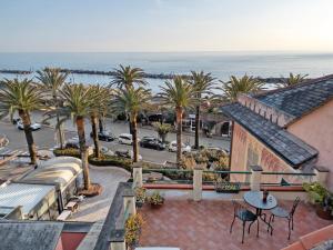 a balcony with palm trees and a view of the ocean at Casa Marcone in Moneglia