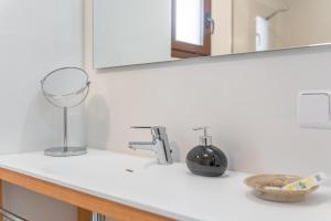 a bathroom counter with a sink and a mirror at Ca sa Tia Lluisa in Santanyi +17 photos