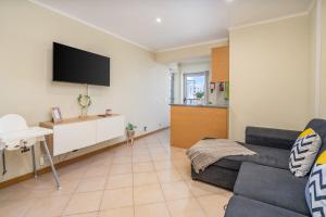 ポルティマンにあるKarol Vaz 4のソファと薄型テレビのあるリビングルーム