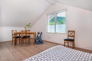 a bedroom with a bed and a table and chairs at Ferienwohnungen Bella Natura in Loffenau
