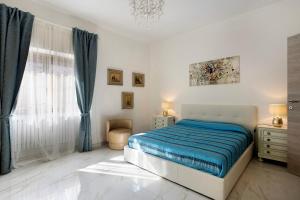 a bedroom with a bed and a chandelier at Ca' Lina in Licciana Nardi