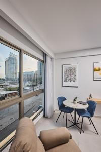 a living room with a large window and a table and chairs at The View - Saint George Hotel in Beirut