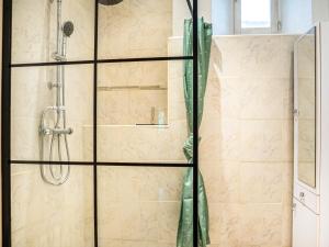 a shower stall with a glass door and a shower constructor at Le Cocon in Villalier +17 photos