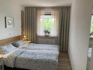 a bedroom with two beds and a window at Fuchsenstein 44 in Oberkreuzberg +37 photos