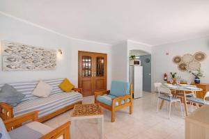 a living room with a couch and a table at Casa Abelha in Armação de Pêra +14 photos