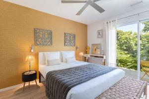a bedroom with a large bed and a large window at Lointaines escapades in Perpignan +85 photos