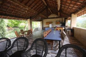 a patio with a table and chairs and a kitchen at Hameau des Oraisonis in Bras-dʼAsse