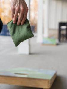 een hand houdt een stuk groen papier vast bij 1st Floor 3BR - Pool, Full Gym, Bikes and Grill! in Yulee