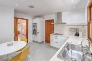 a kitchen with a sink and a table at Sant Antoni in Santanyi