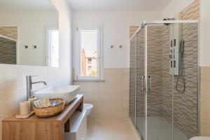a bathroom with a sink and a shower at Centenari Longevity Rooms Lotzorai in Lotzorai