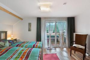 a bedroom with a bed and a large window at Haus Ruheplatzerl in Ruhpolding