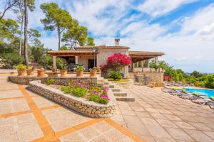 a villa with a swimming pool and a resort at Es Bosquet in Inca