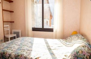 a bedroom with a bed and a window at Chalet à Aulus-Les-Bains in Aulus-les-Bains