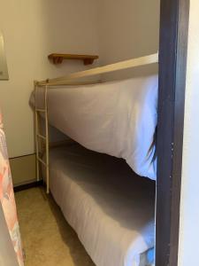 a bunk bed in a small room with a mattress at Appt de montagne Araches in Arâches-la-Frasse