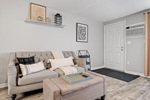 a living room with a couch and a table at Stylish 1st Flr 1Bed Condo-Close to Downtown Dover in Dover