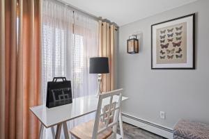 a white desk in a room with a window at Stylish 1st Flr 1Bed Condo-Close to Downtown Dover in Dover
