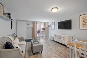 a living room with a couch and a flat screen tv at Stylish 1st Flr 1Bed Condo-Close to Downtown Dover in Dover