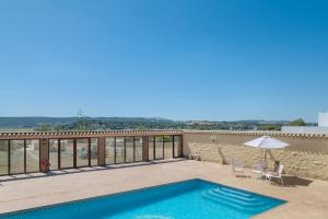 a swimming pool on the balcony of a house at Casa Altamar in Barbate