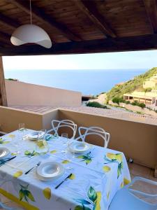 a table with a blue and yellow table cloth at Casa il Bouganville - sea view Costa Paradiso in Costa Paradiso