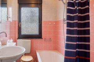 a bathroom with a sink and a tub and a toilet at Fewo Gundlach in Lichtenau +17 photos