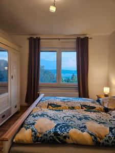 a bedroom with a bed and a large window at Ferienoase Weitblick in Rinteln