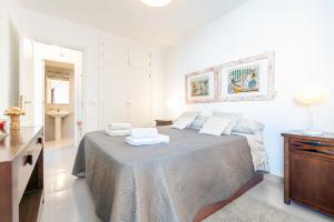 a bedroom with a bed with two towels on it at Taiko in Port de Pollensa