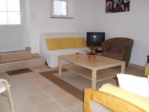 a living room with a couch and a table at Gîte Mélany in Chargé