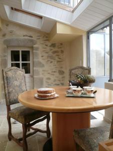 a table with a cake on it in a room at Le Rockin' Chair in Surzur